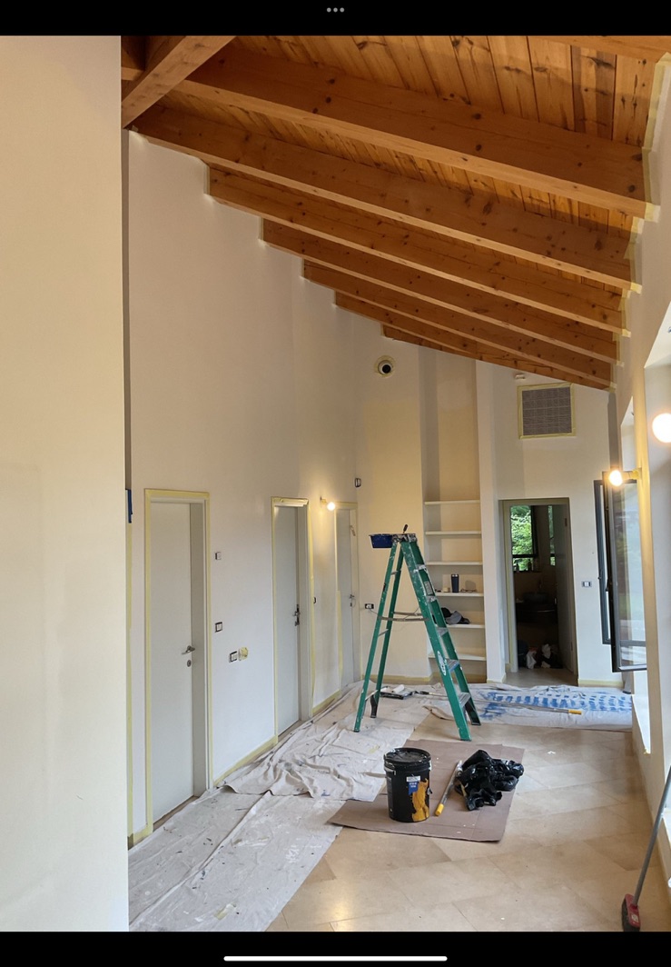 Interior preparation in a room with exposed wood ceiling beams