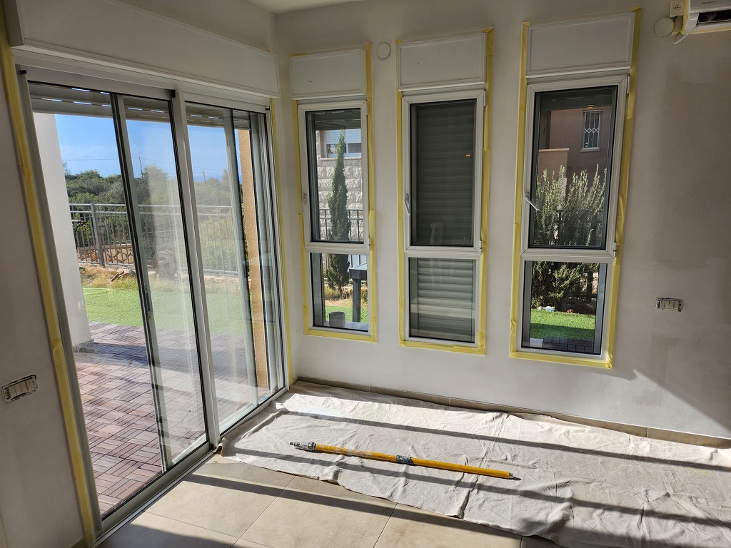 Window frames carefully masked before interior painting
